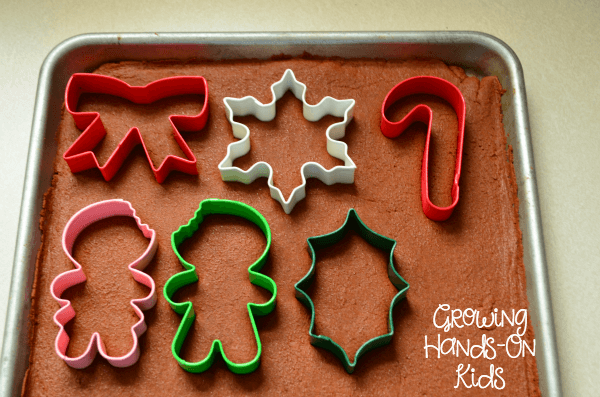 An easy recipe for homemade cinnamon applesauce ornaments, a perfect sensory experience for kids.