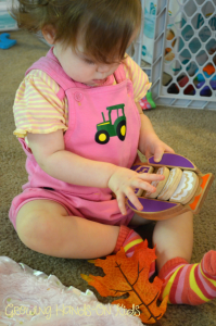 playing with fall sensory basket for baby.