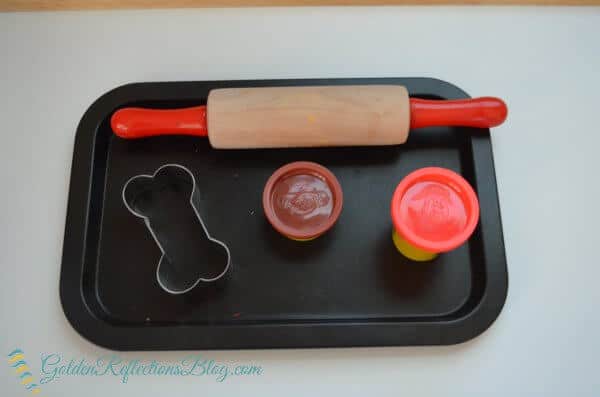 Dog themed play dough tray for montessori inspired tot school week. 