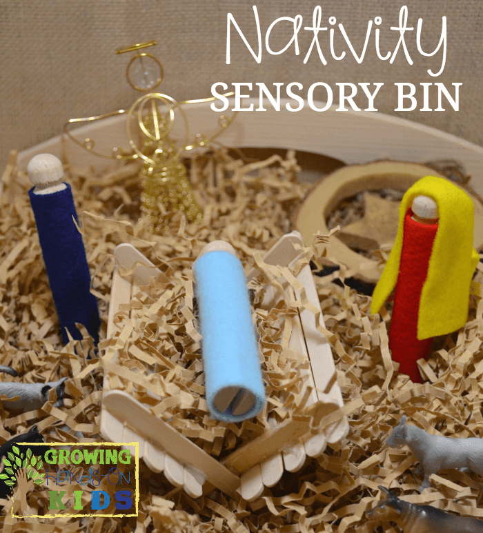 An easy, DIY Nativity sensory bin, perfect for the Advent season with crinkle paper, peg people with felt clothing and hair, a wire angel and toy animals.