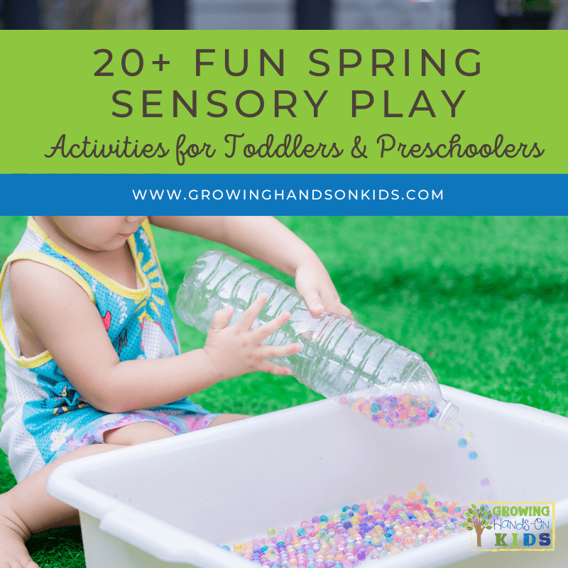 Picture of child sitting on the grass pouring colorful water beads out of a water bottle into a white plastic bin. Green text overlay at the top says "20+ fun spring sensory play activities for toddlers and preschoolers."