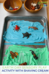 Earth day sensory play activity with shaving cream and miniature animals.