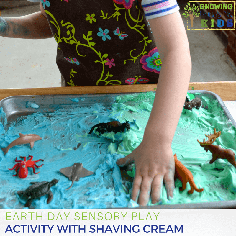 Earth day sensory play activity with shaving cream and miniature animals.