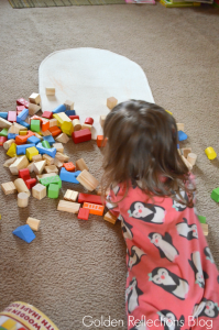 Playing with wooden blocks for developmental play. www.GoldenReflectionsBlog.com