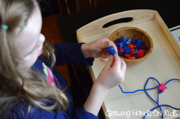 Letter T activities, stringing train beads.