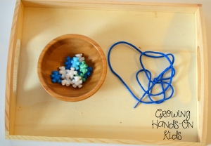 Stringing bear beads for letter B activities for tot-school.
