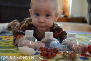 Christmas discovery bottles for baby, perfect for tummy time by the tree.