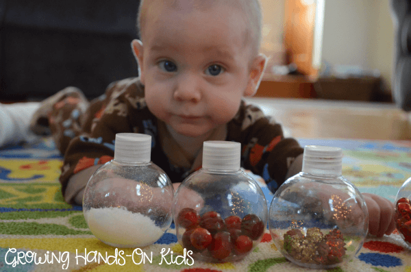 Christmas discovery bottles for baby, perfect for tummy time by the tree. 