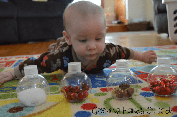 Christmas discovery bottles for baby, perfect for tummy time by the tree. 