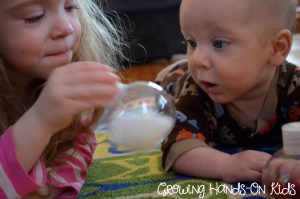 Christmas discovery bottles for baby, perfect for tummy time by the tree.