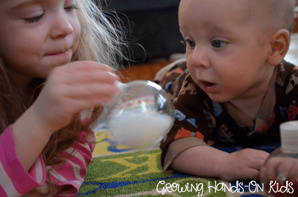 Christmas discovery bottles for baby, perfect for tummy time by the tree. 