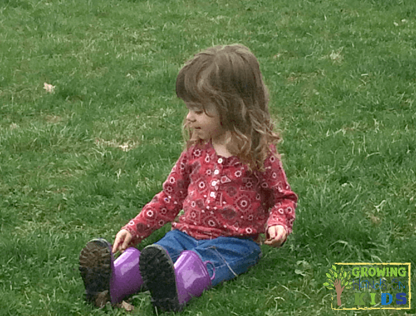 Child sitting and listening to nature sounds. Listening Scavenger Hunt for Kids.