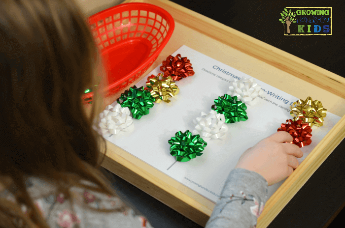 Christmas bow pre-writing line practice for kids. Includes a free printable.