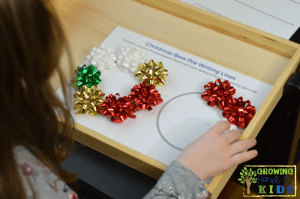 Christmas bow pre-writing line practice for kids. Includes a free printable.