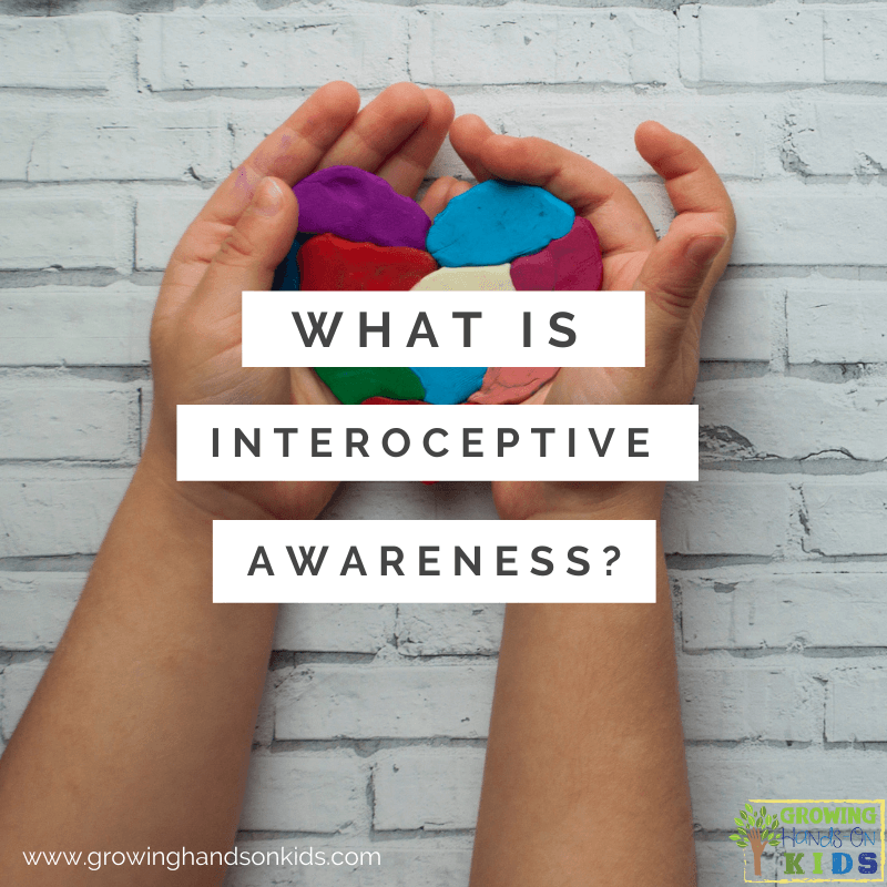 white brick background with child's hands hold a multi-colored clay heart. White text overlay with gray words that say "What is interoceptive awareness?"