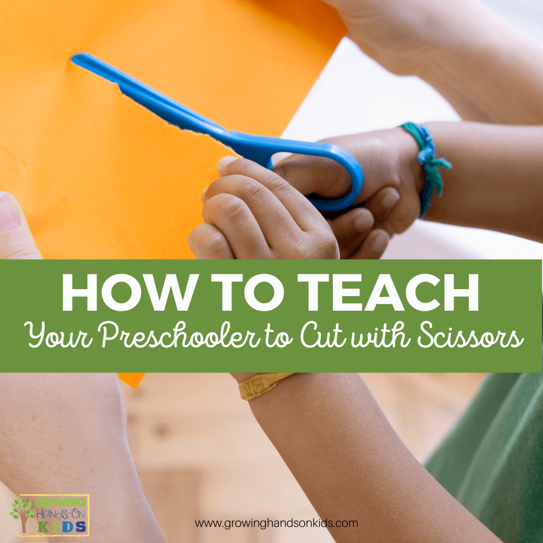 Background is a picture of a child holding a pair of blue safety scissor, cutting across an orange piece of paper. Adult hands on holding the paper on either side of the child's hands. Green text overlay across the top with white text says "How to teach your preschooler to cut with scissors".